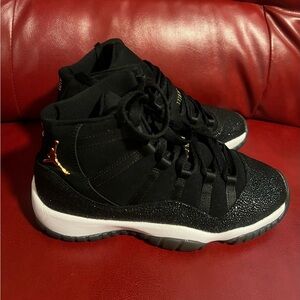Jordan 11 Retro Black and Gold Sneakers